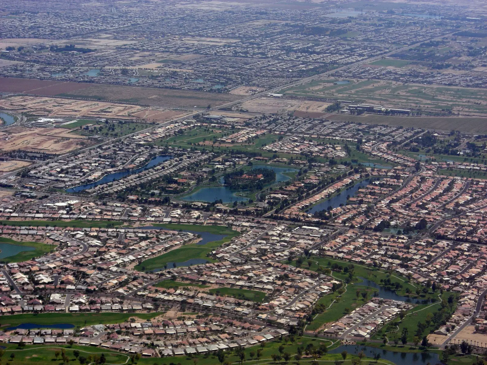 Aerial view of Chandler, Arizona neighborhoods laid out around lakes and golf course greens